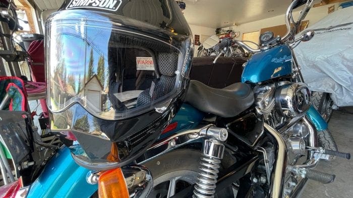 Simpson Speed Bandit helmet sitting on the back of a Harley Davidson