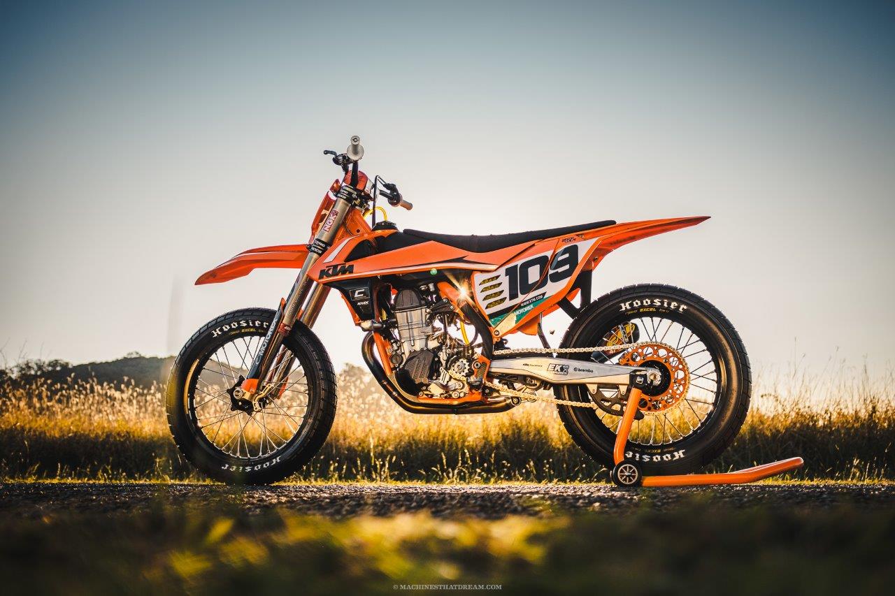 Custom KTM flat tracker on a road at sunset