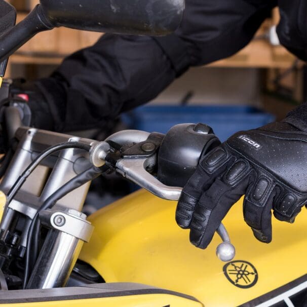 Simon Bertram wearing the Icon SuperDuty II gloves pressing the clutch