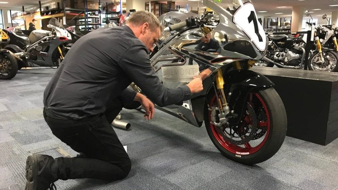 A dealer places a label on a V4 SS at a dealership