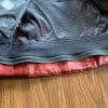Bottom zipper for attaching jacket to riding pants