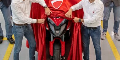 a pair of men revealing the Ducati Multistrada V4 S