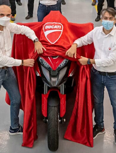 a pair of men revealing the Ducati Multistrada V4 S