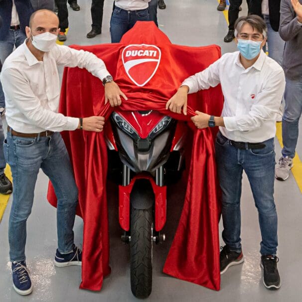 a pair of men revealing the Ducati Multistrada V4 S