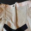Closeup of perforated leather on the Falcon pants