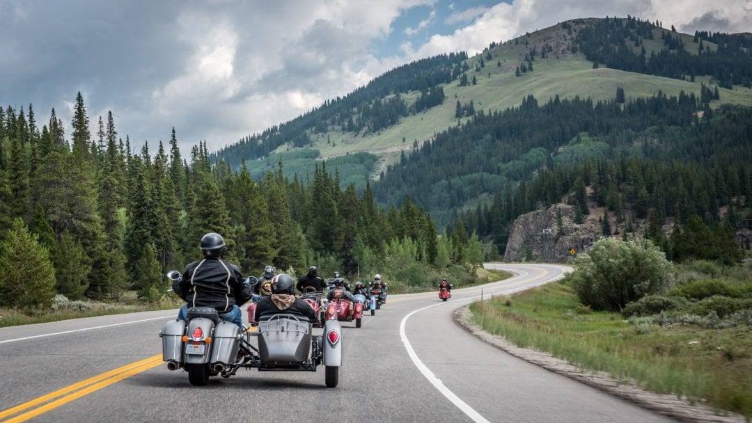 A back view of two veterans riding an Indian Motorcycle for the Veterans Charity Ride