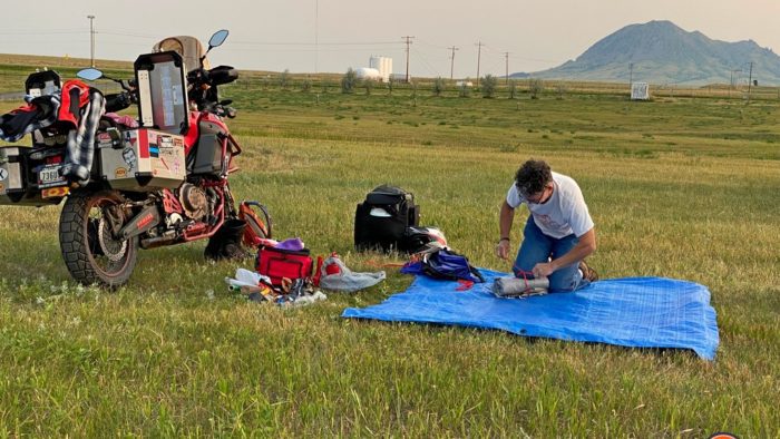 A rally participant packing up his camp before starting the journey home.