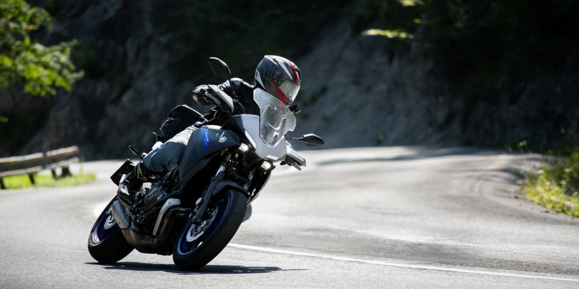 Motorcycle rider taking the twisties at speed. Photo by Jakub Sisulak