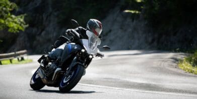 Motorcycle rider taking the twisties at speed. Photo by Jakub Sisulak