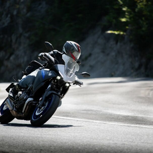 Motorcycle rider taking the twisties at speed. Photo by Jakub Sisulak