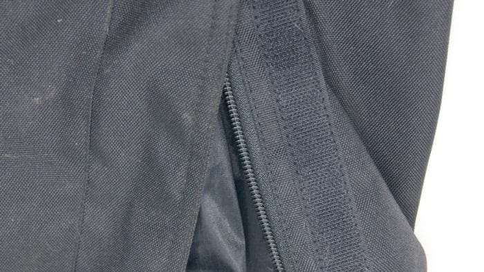 A close-up view of the zippers and velcro at the hem of the Gryphon Moto Indy Pants.