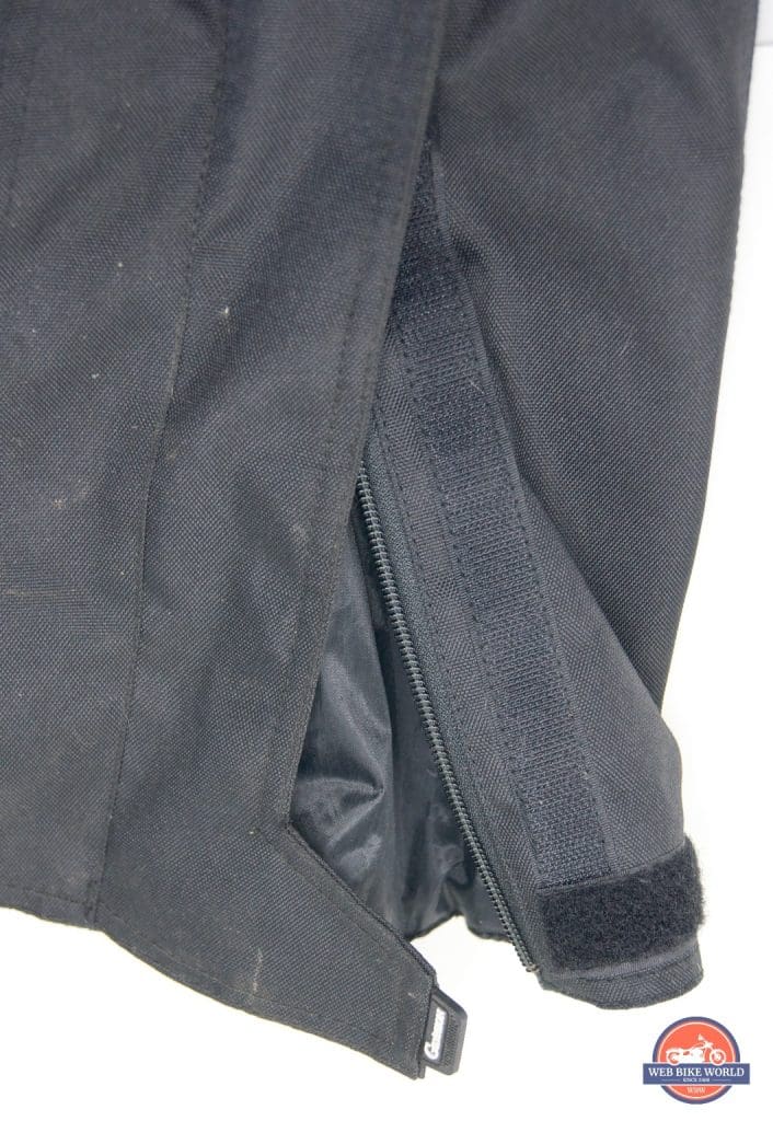 A close-up view of the zippers and velcro at the hem of the Gryphon Moto Indy Pants.