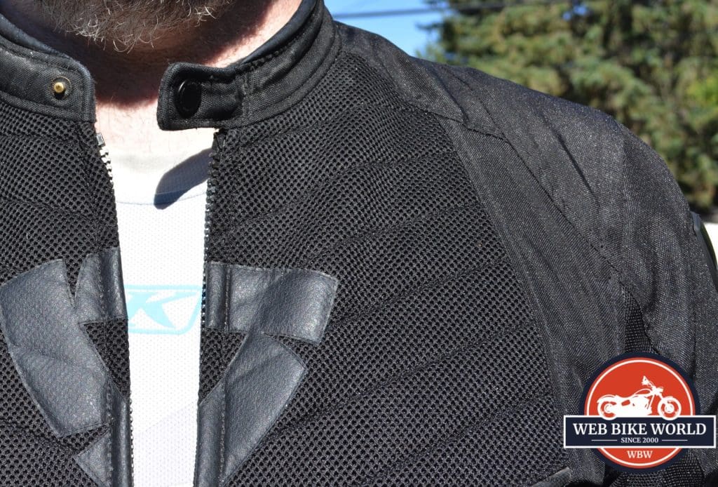 A view of the KLIM Aggressor -1.0 Cooling Shirt underneath the model's usual motorcycle attire.