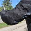 A back left elbow view of the Arc Air Mesh jacket, with focus on the accordion zones