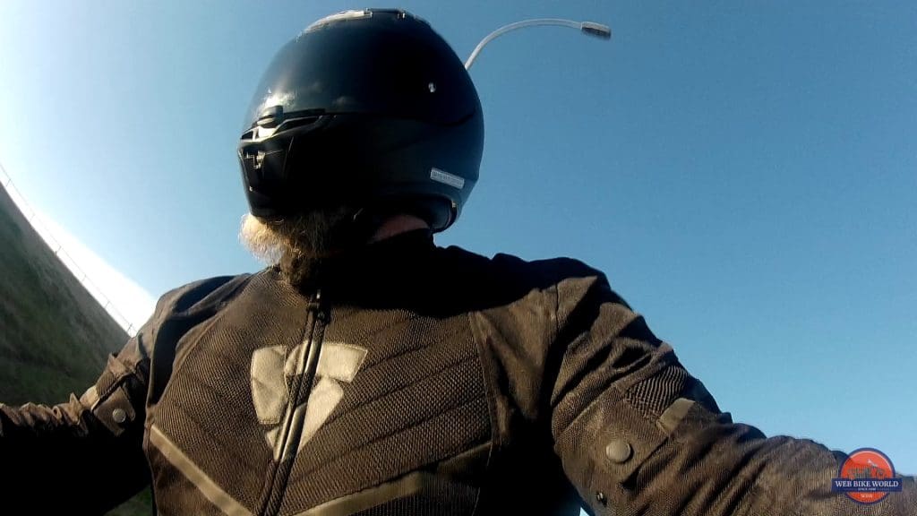 A front chest view of a rider wearing the Arc Air Mesh jacket