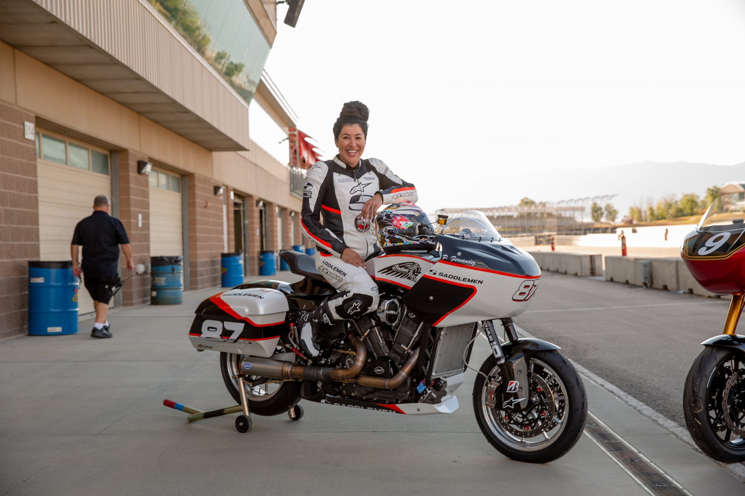 a side profile of Patricia Fernandez on her custom-built Indian Bagger, set for the Bagger Racing League