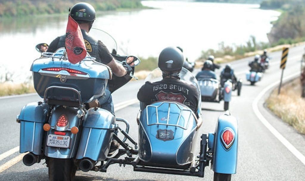 A back view of two veterans riding an Indian Motorcycle for the Veterans Charity Ride