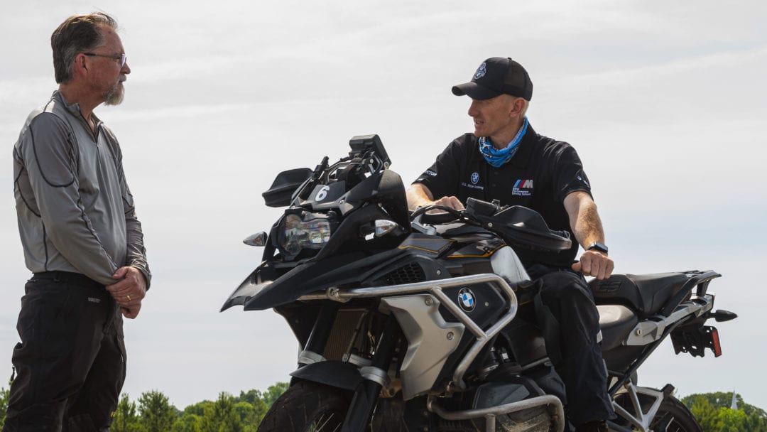 two instructors from the BMW Rider Academy talking motorcycle jargon