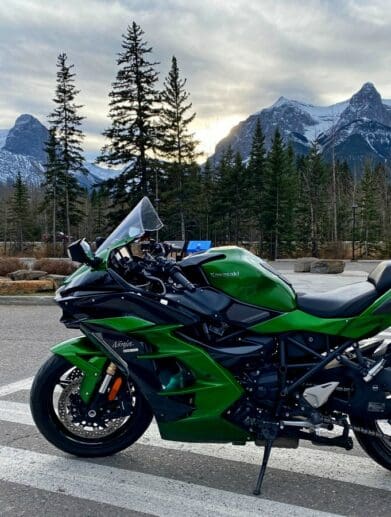 A view of a Kawasaki Ninja H2SX SE with mountains in the background