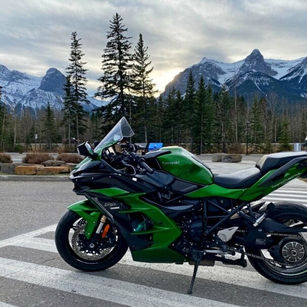 A view of a Kawasaki Ninja H2SX SE with mountains in the background