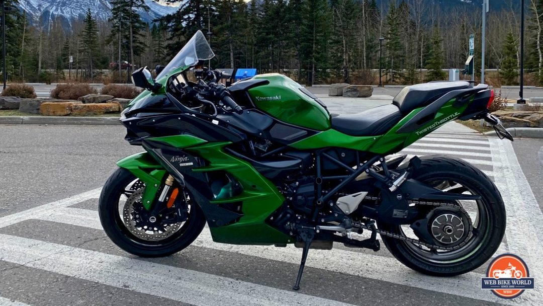 A view of a Kawasaki Ninja H2SX SE with mountains in the background