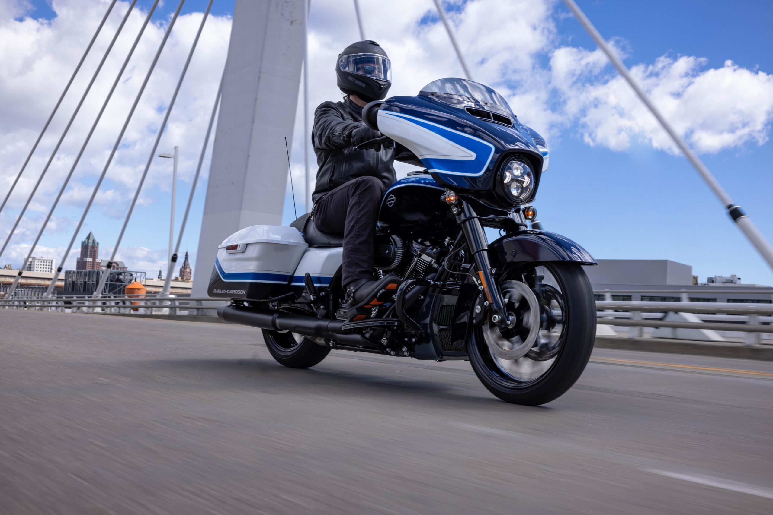 a side view of a rider trying out the all-new 2021 Harley Davidson Street Glider hot-rod bagger in a limited edition Arctic Blast paint job, completed by Gunslinger Custom Paint