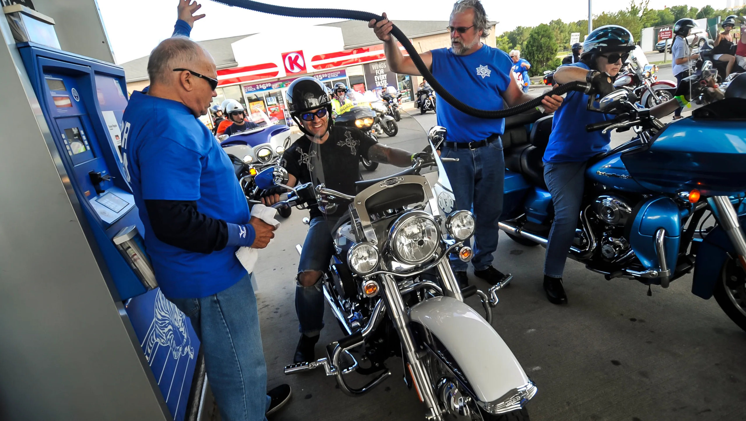 A view of a rider being helped at the gas station during America's 911 Foundation