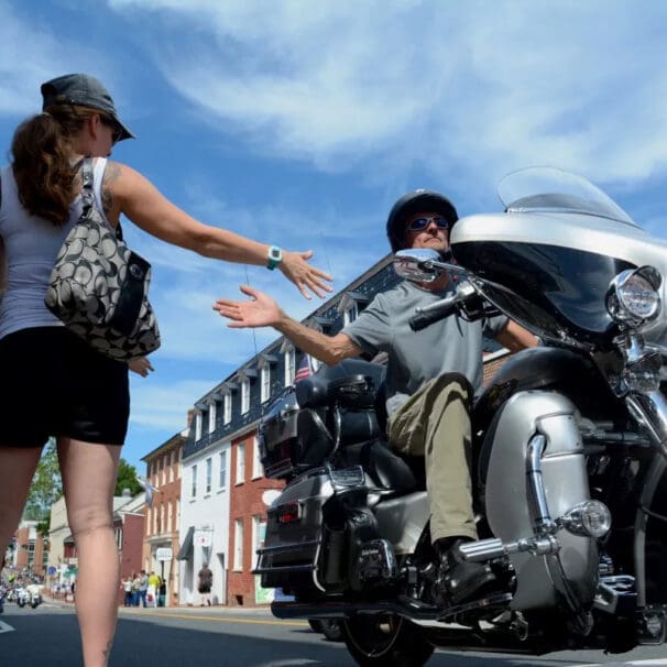 A view of a rider joining hands with a grateful civilian in commemoration of America's 911 Foundation Ride