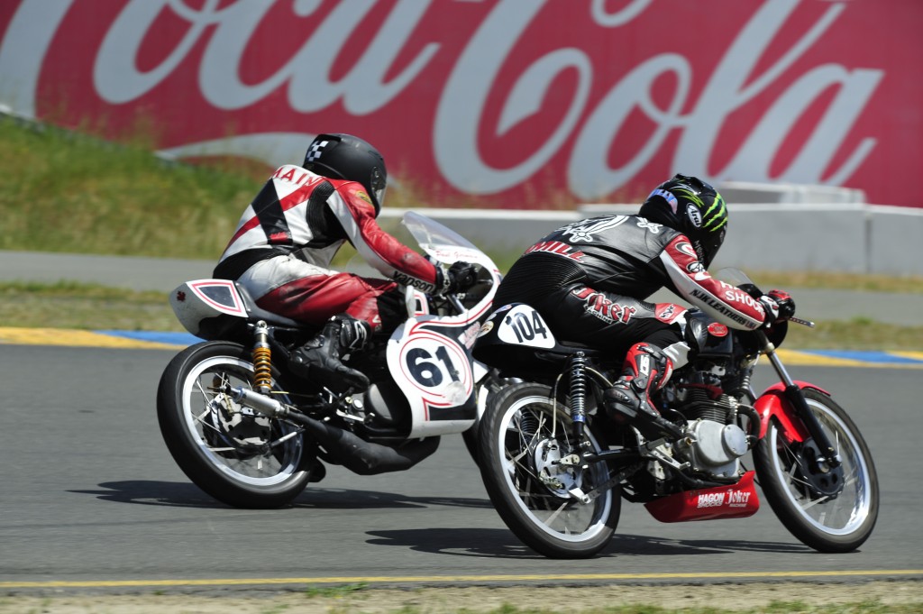 A view of riders connected with the American Historic Racing Motorcycle Association (AHRMA) Leaning into the twisties
