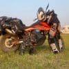 A KTM 790 Adventure with riding gear draped over it.