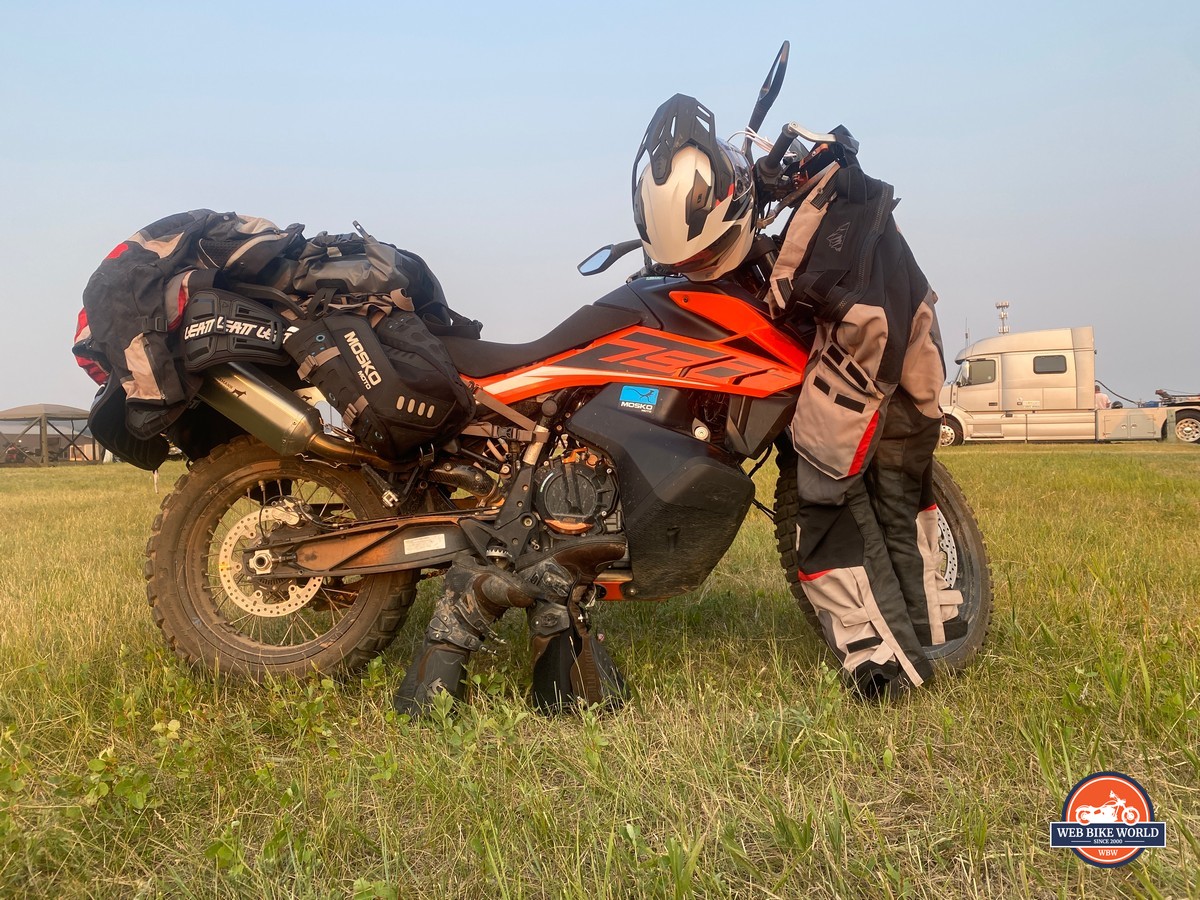 A KTM 790 Adventure with riding gear draped over it.