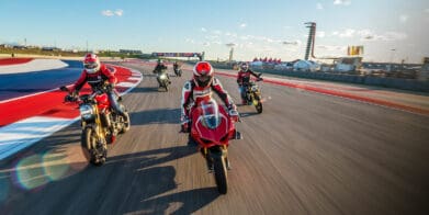 A view of registrars of the 23019 Ducati Island Experience, trying out the COTA MotoGP track in a parade lap.