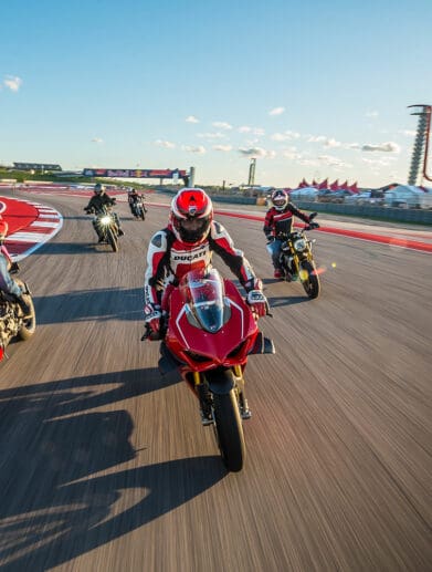A view of registrars of the 23019 Ducati Island Experience, trying out the COTA MotoGP track in a parade lap.