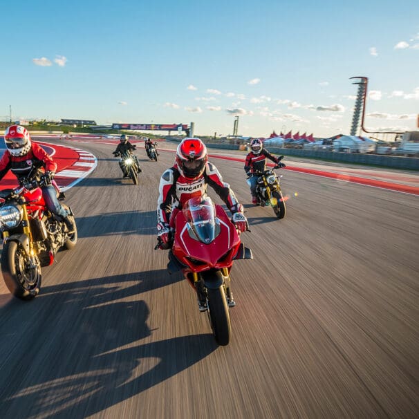 A view of registrars of the 23019 Ducati Island Experience, trying out the COTA MotoGP track in a parade lap.