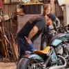 Indian Larry and Paul Cox taking a peek at the custom motorcycle built by Indian Larry, Paul Cox, and Keino Sasaki