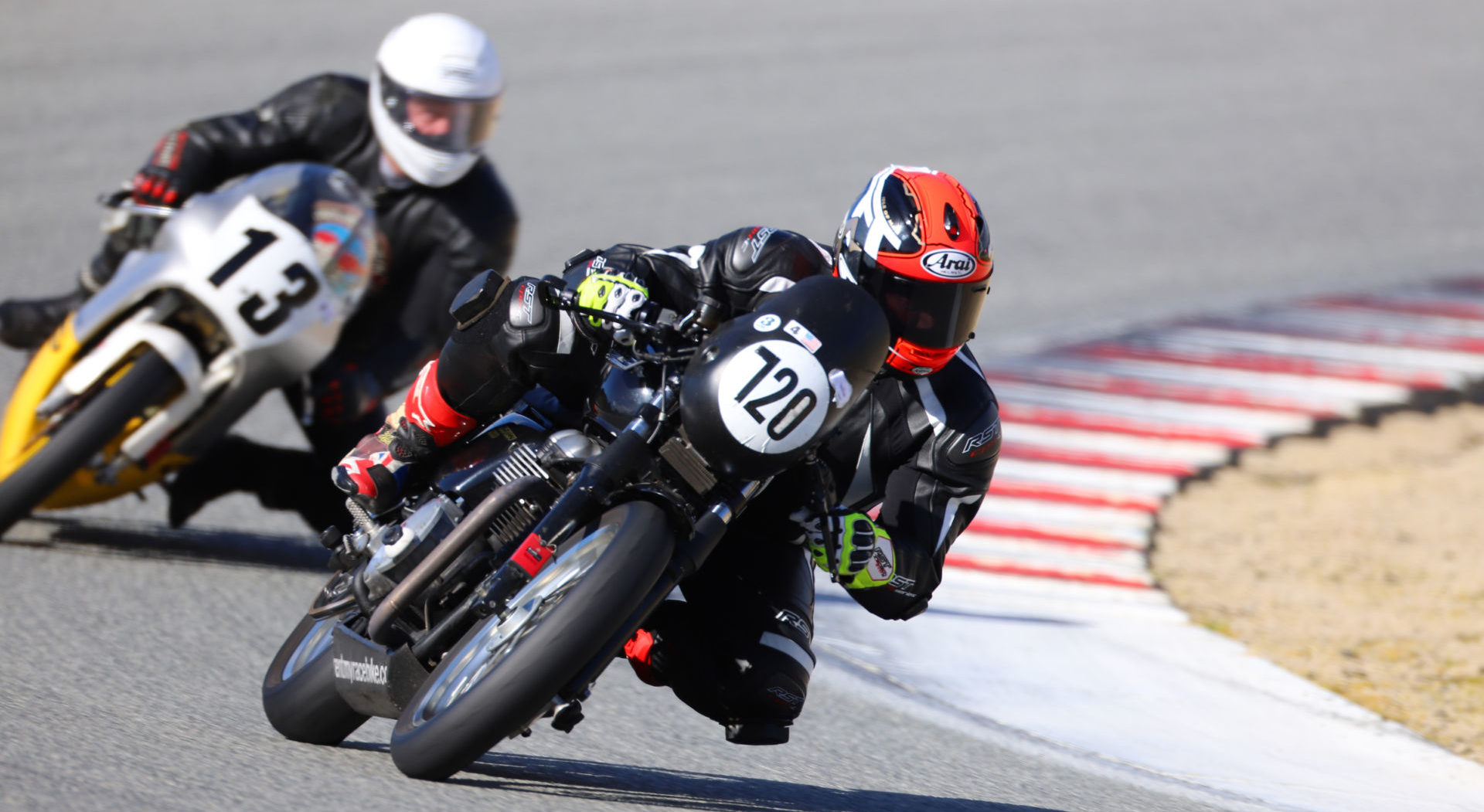 A view of riders connected with the American Historic Racing Motorcycle Association (AHRMA) Leaning into the twisties