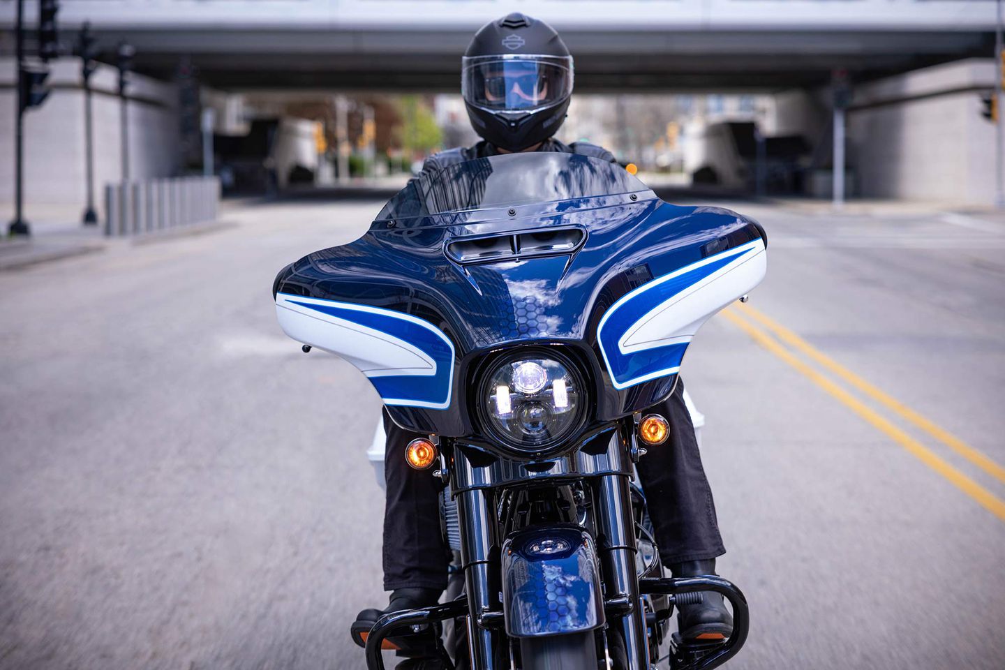 a front view of a rider trying out the all-new 2021 Harley Davidson Street Glider hot-rod bagger in a limited edition Arctic Blast paint job, completed by Gunslinger Custom Paint