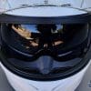 A view of the white Outrush R Modular Helmet, with the sunglasses option flipped down