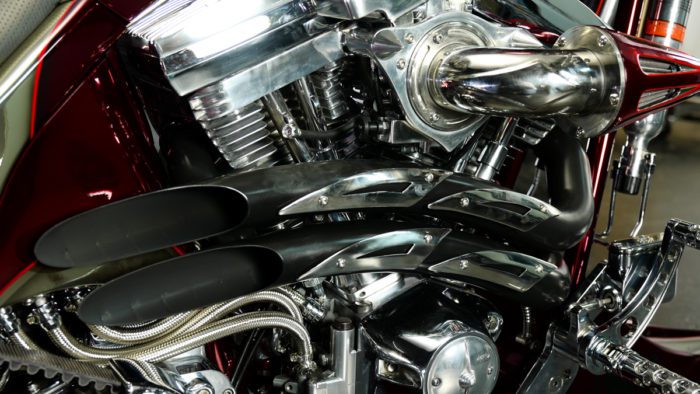 a view of the exhaust and engine onthe Bad Land 1992 EVO 300 Wide Tire Chopper, also known as ‘The Hades Chopper’. a view of the exhaust and engine onthe Bad Land 1992 EVO 300 Wide Tire Chopper, also known as ‘The Hades Chopper’.