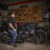 Nikko Hurtado, sitting astride the custom motorcycle built by Indian Larry, Paul Cox, and Keino Sasaki