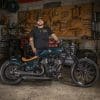 Nikko Hurtado, next to his bike - the custom motorcycle built by Indian Larry, Paul Cox, and Keino Sasaki