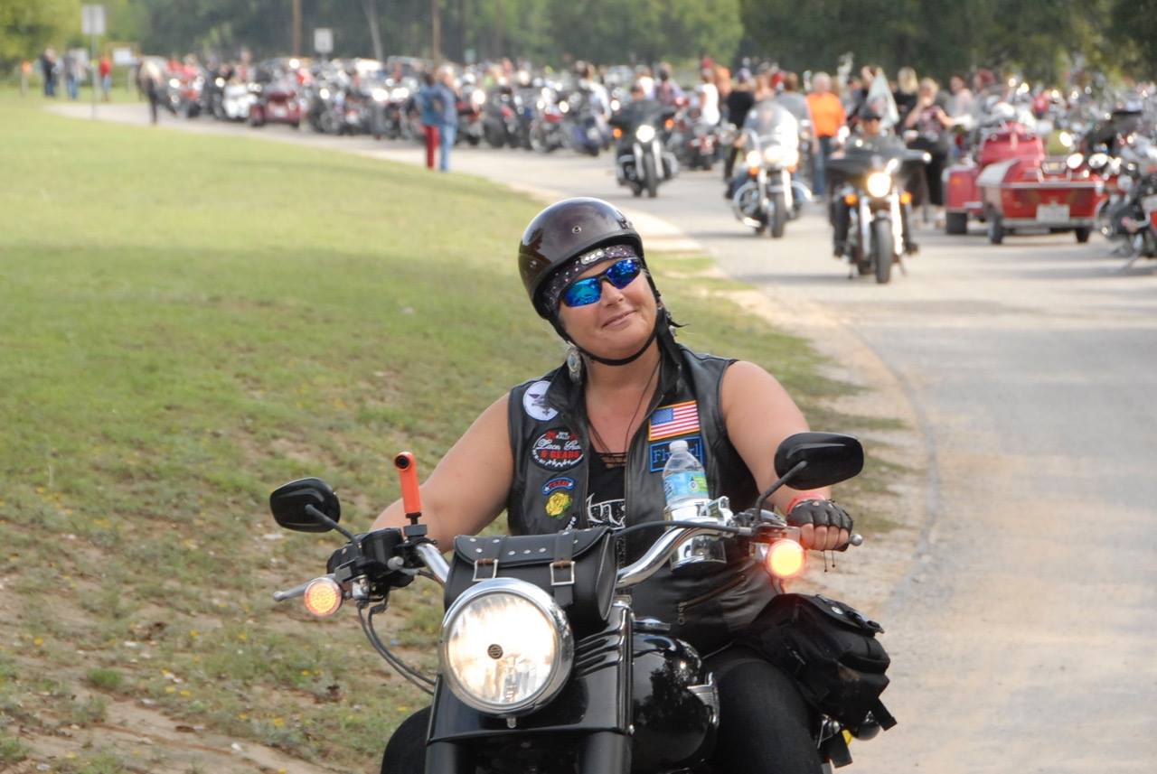 A picture of various ladies in leather, riding together for a cause.