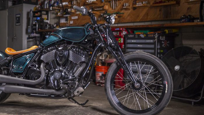 A pipe-side view of the custom motorcycle built by Indian Larry, Paul Cox, and Keino Sasaki