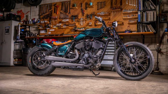 a pipe side view of the custom motorcycle built by Indian Larry, Paul Cox, and Keino Sasaki