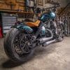 a rear 3/4 view of the custom motorcycle built by Indian Larry, Paul Cox, and Keino Sasaki