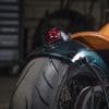 a rear fender view of the integrated taillight, done by Paul Cox, on the custom motorcycle built by Indian Larry, Paul Cox, and Keino Sasaki