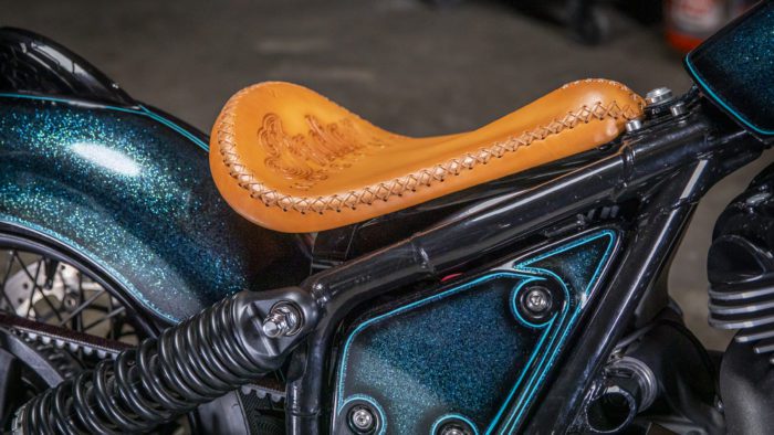 The leather tooling, performed by Paul Cox, on the custom motorcycle built by Indian Larry, Paul Cox, and Keino Sasaki