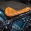 The leather tooling, performed by Paul Cox, on the custom motorcycle built by Indian Larry, Paul Cox, and Keino Sasaki