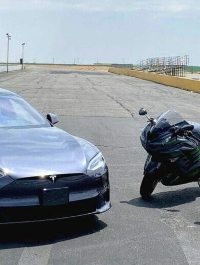 A view of a Tesla Model S Plaid, a 2022 Suzuki Hayabusa and a 2021 Kawasaki Ninja ZX-14R ready to race