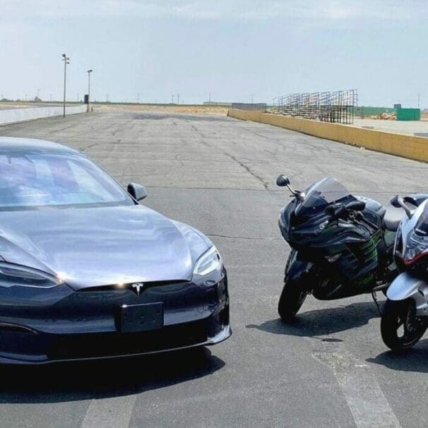 A view of a Tesla Model S Plaid, a 2022 Suzuki Hayabusa and a 2021 Kawasaki Ninja ZX-14R ready to race